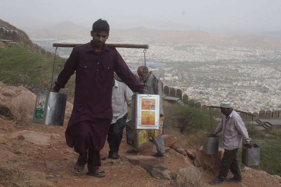 pics of People carrying water on the shoulders