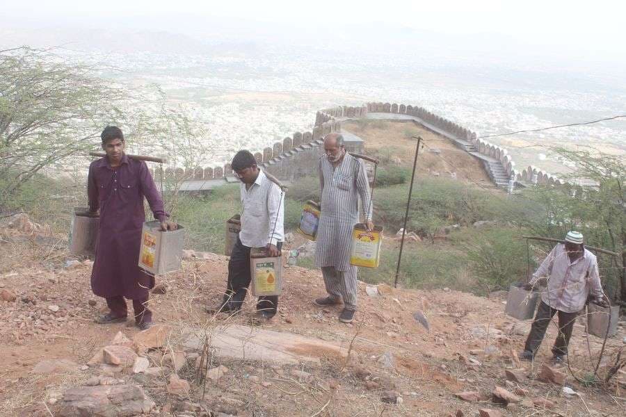 pics of People carrying water on the shoulders