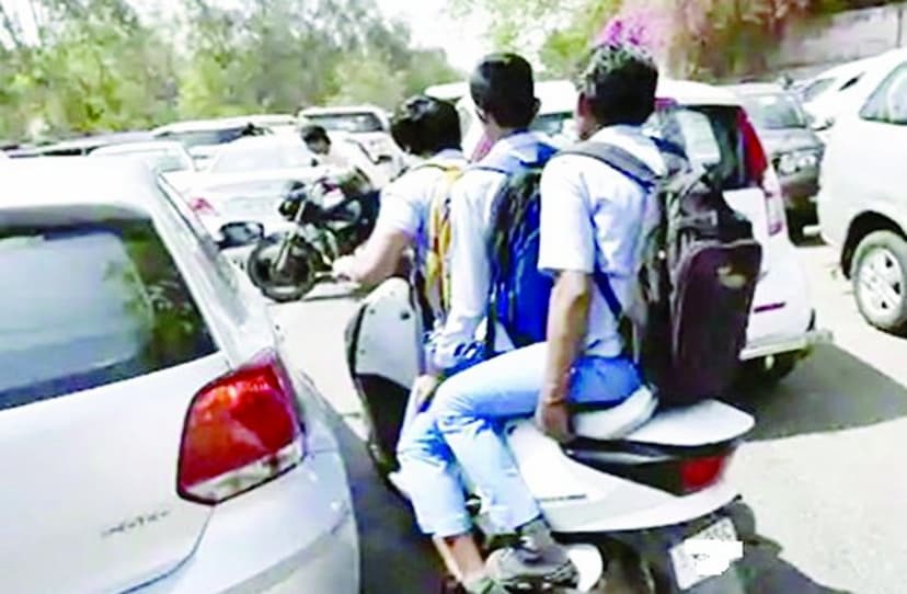 Minor school children going to school on two wheelers.