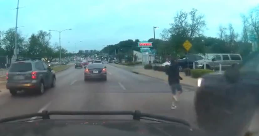 Guy jaywalking gets hit by a truck