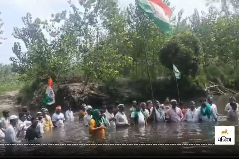 Farmers hoisted flag in water and protested demanding construction of a bridge on Hindon river